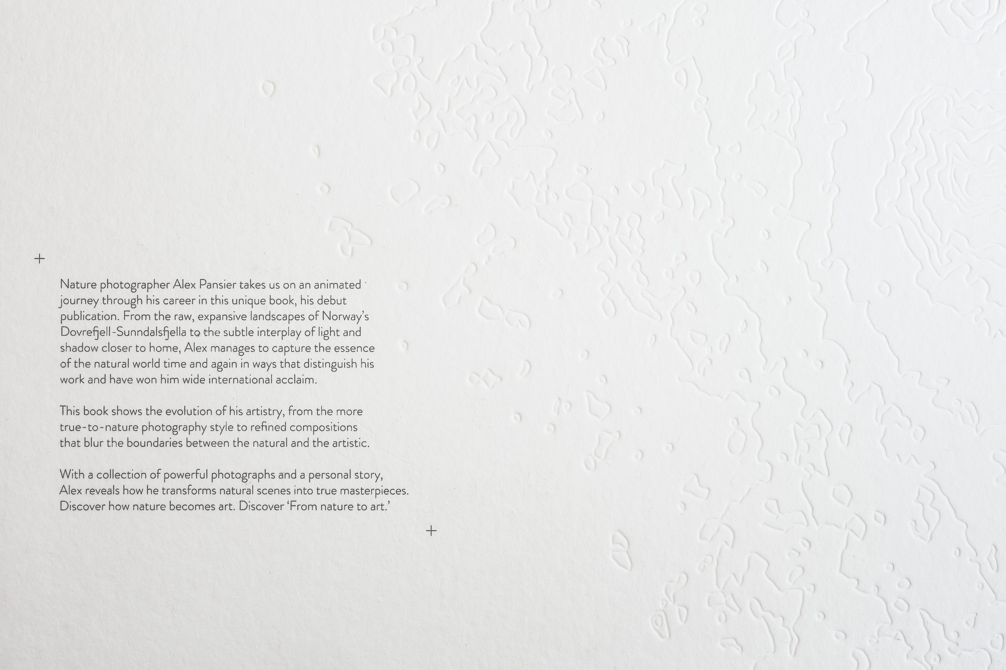 Back cover of the Standard edition with the book description and embossed topographic lines.